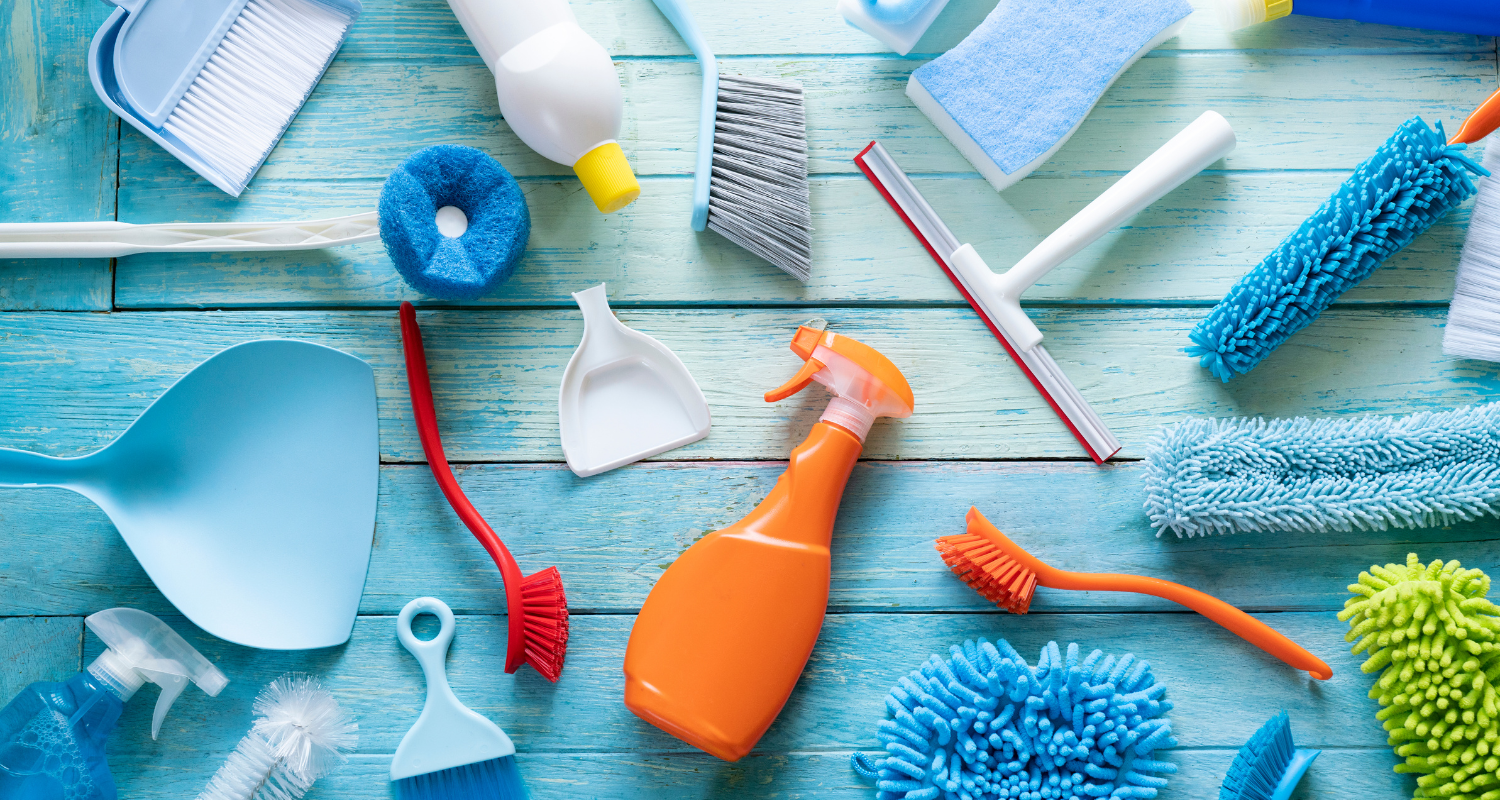Assortment of cleaning goods for performing deep clean in home or office, banner image for deep cleaning blog.