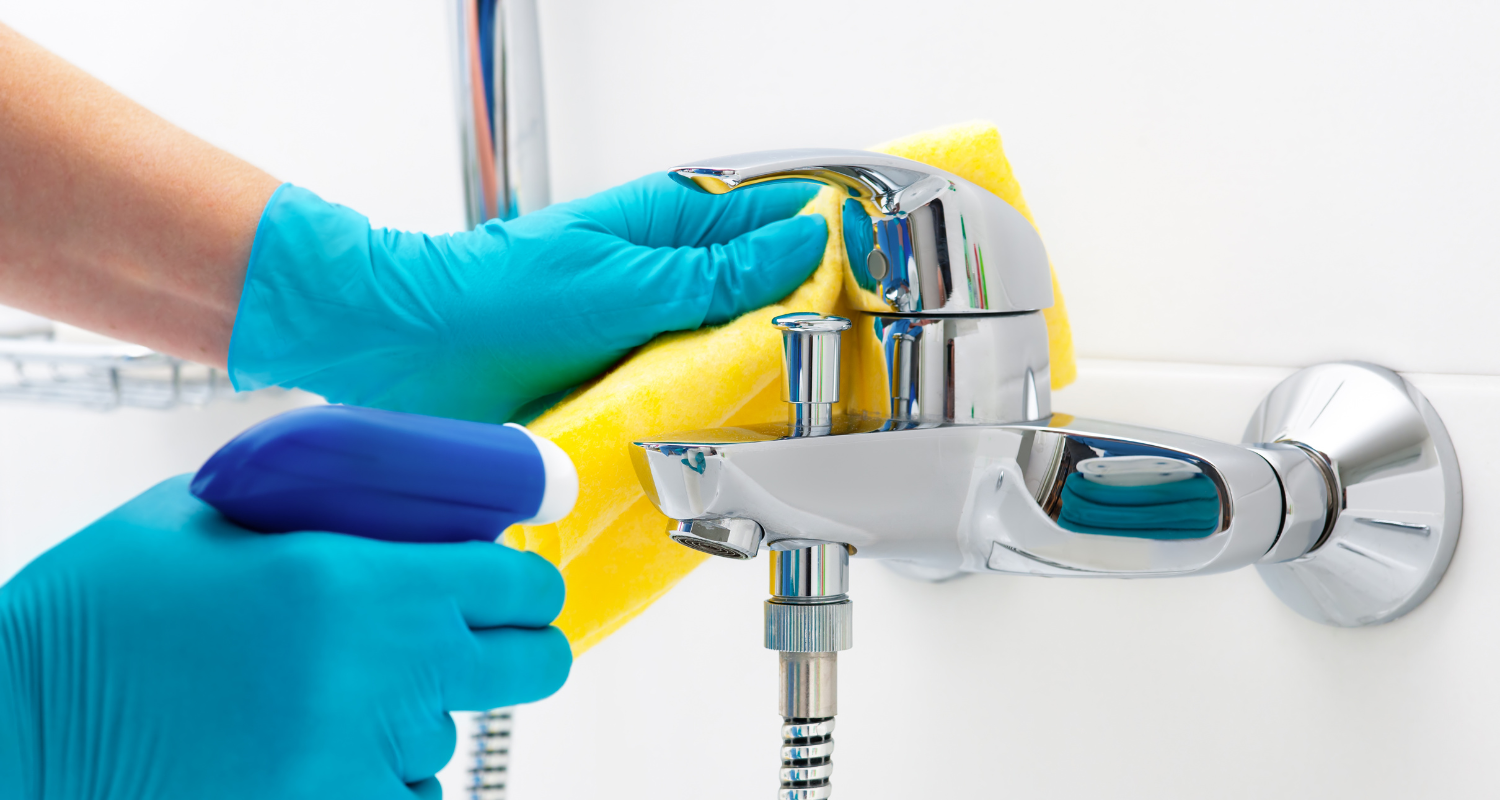 Professional team performing deep clean on a shower fitment, banner image for deep cleaning blog.